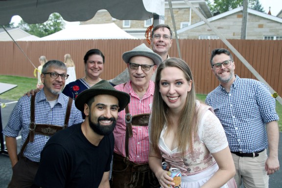 A group of smiling people wearing German garb.